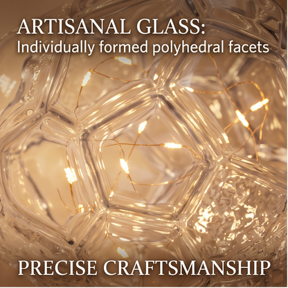 Angled view of the glass globe lamp showing its gold-finish base and visible button