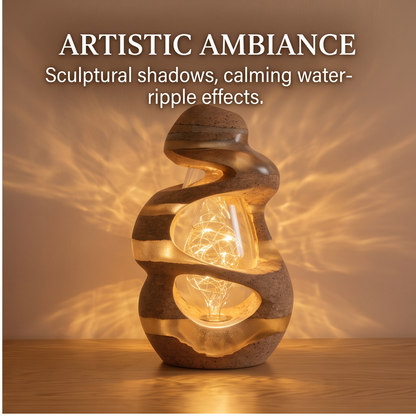 Front view of the glowing cork and resin sculptural lamp casting water-ripple shadows on the wall