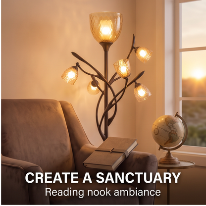Branching floor lamp with textured glass shades glowing beside a reading chair
