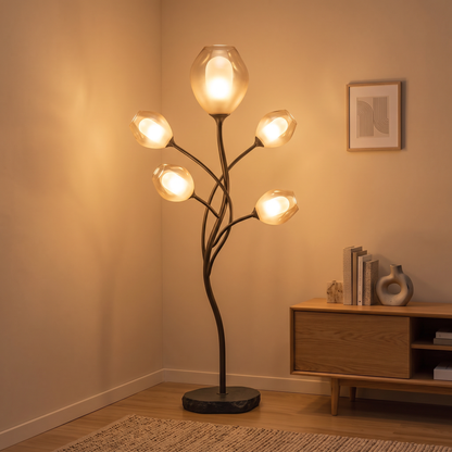 Two angled views of the sculptural branch floor lamp showing its glowing amber shades